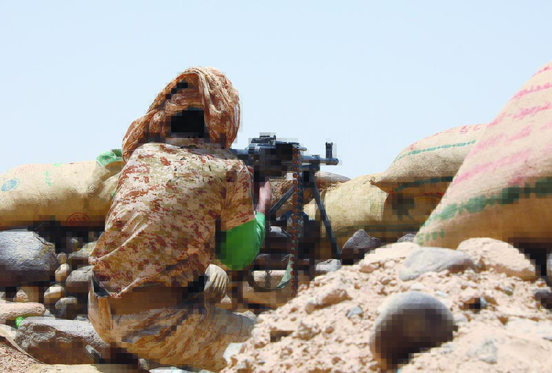 MARIB, Yemen: A fighter with forces loyal to Yemen's Saudi-backed government holds a position against Houthi rebels in Yemen's northeastern province of Marib. - AFPn