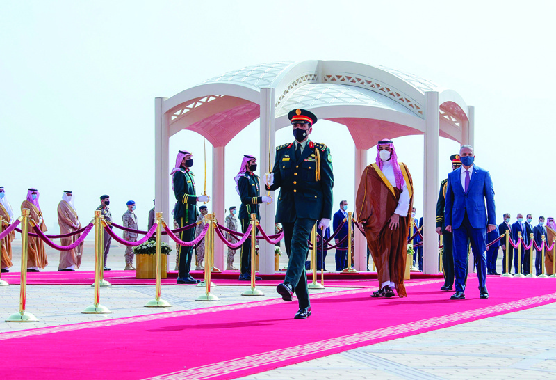 RIYADH: Crown Prince Mohammed bin Salman (second right) and Iraqi Prime Minister Mustafa Al-Kadhemi (right) reviewing guard of honor at the start of a visit in the kingdom. - AFPn