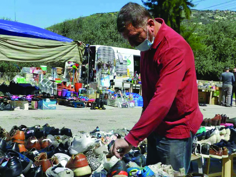 A shoe seller at Souk al-Marj arranges his products on April 13, 2021. - Xinhua photosn