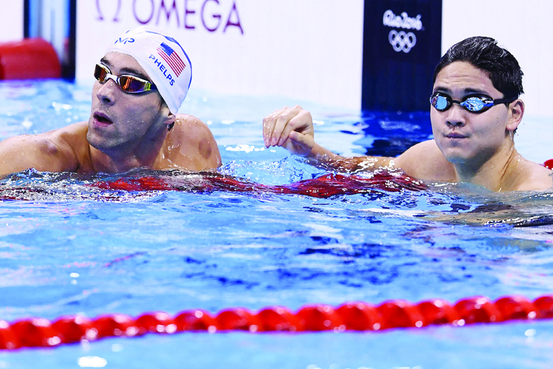 RIO DE JANEIRO: In this file photo taken on Aug 11, 2016, USA's Michael Phelps (left) and Singapore's Joseph Schooling react during a swimming event at the Rio 2016 Olympic Games at the Olympic Aquatics Stadium. - AFP n