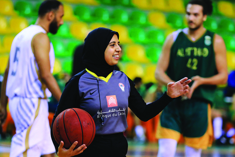 ALEXANDRIA: Egyptian Basketball referee Sarah Gamal gestures while holding a ball during a match between the Al-Ittihad and Al-Geish teams at the Al-Ittihad Al-Sakandari Arena in the country's northern city of Alexandria, on April 17, 2021. - AFPnn