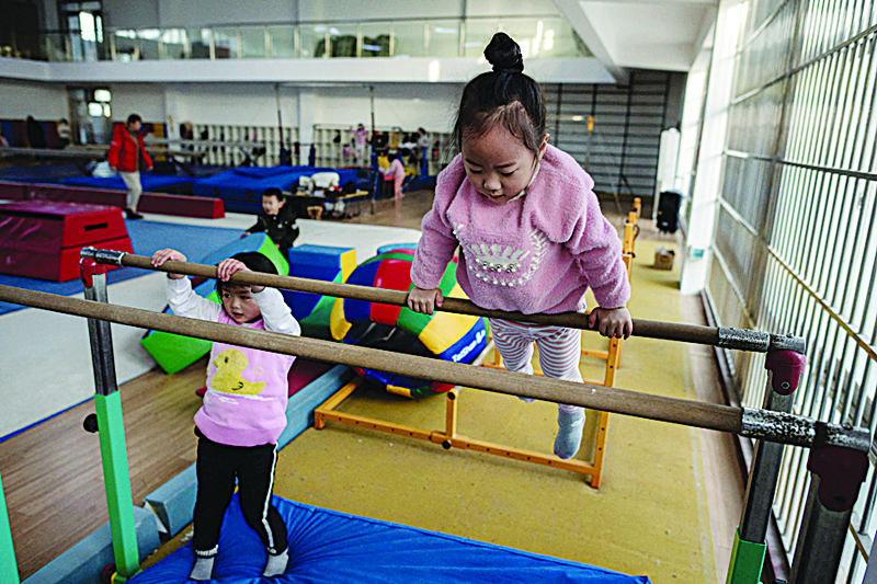 In this picture taken on January 11, 2021, young gymnasts train at the Li Xiaoshuang Gymnastics School in Xiantao, Hubei province. n