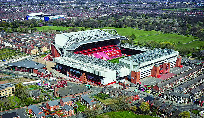 LIVERPOOL: An aerial photo shows Anfield stadium (right), home of English Premier League football club Liverpool, and Goodison Park, home of Premier League club Everton (left), in Liverpool, north west England yesterday. - AFPn