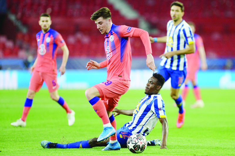 SEVILLE: Chelsea's English midfielder Mason Mount (left) vies with FC Porto's Nigerian defender Zaidu Sanusi during the UEFA Champions League first leg quarter final football match between FC Porto and Chelsea FC at the Ramon Sanchez Pizjuan stadium in Seville on Wednesday. - AFPn
