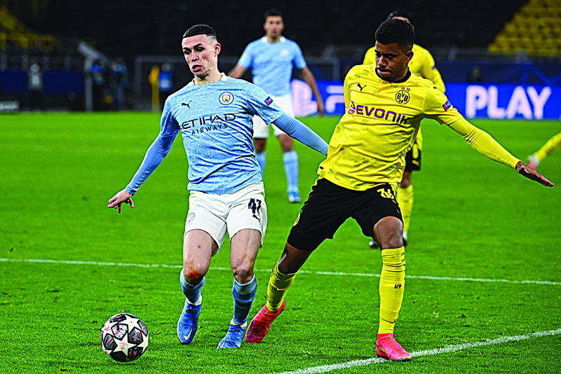 DORTMUND: Manchester City's English midfielder Phil Foden (left) and Dortmund's German forward Ansgar Knauff vie for the ball during the UEFA Champions League quarterfinal second leg football match on Wednesday. - AFP n