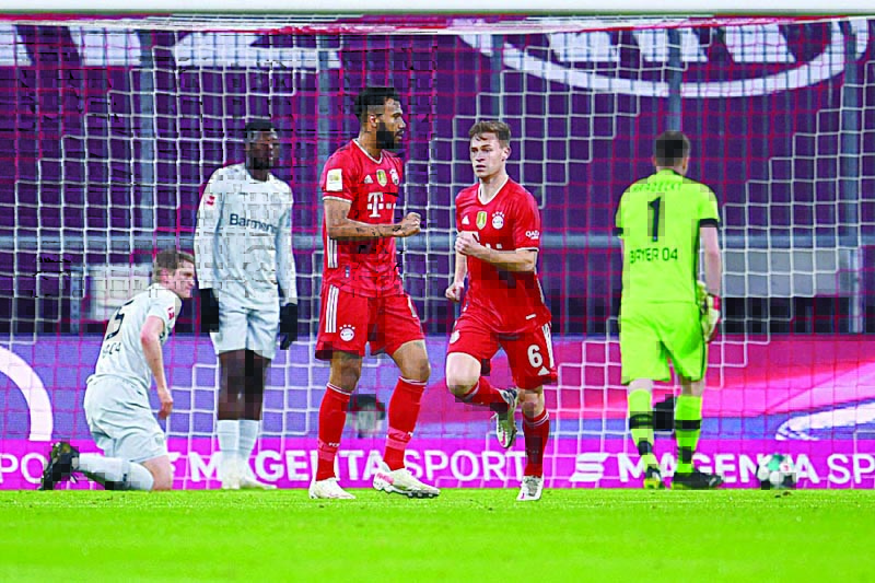 MUNICH: Bayern Munich's Cameroonian forward Eric Maxim Choupo-Moting (left) celebrates with Bayern Munich's German midfielder Joshua Kimmich after scoring the opening goal during the German first division Bundesliga football match FC Bayern Munich vs Bayer 04 Leverkusen in Munich, southern Germany, on Tuesday. - AFPn