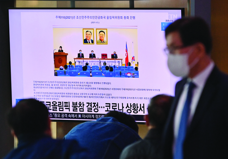 SEOUL: People watch a television screen showing a news report about North Korea's decision not to participate in the Tokyo Olympics due to the Covid-19 pandemic, at a railway station in Seoul yesterday. - AFPn