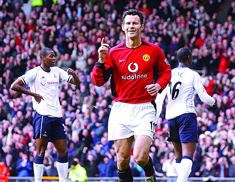 MANCHESTER: In this file photo taken on March 20, 2004 Manchester United's Ryan Giggs celebrates after scoring to make it 1-0 against Spurs during the Premiership clash at Old Trafford Stadium, Manchester. - AFPn