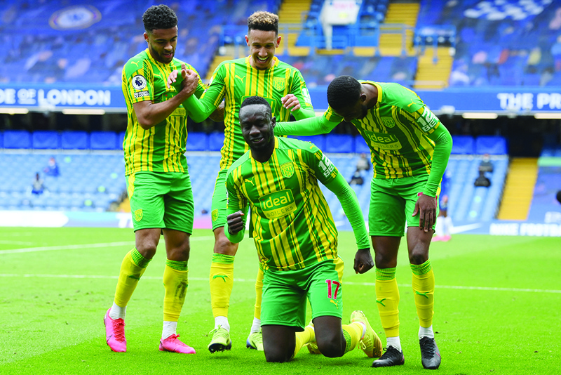 LONDON: West Bromwich Albion's Senegalese striker Mbaye Diagne (second right) celebrates with teammates after scoring his team's fourth goal during the English Premier League football match between Chelsea and West Bromwich Albion at Stamford Bridge in London yesterday. - AFPn