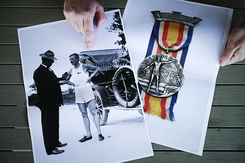 ABZAC: Clement Genty, associate researcher at the National School of Arts and Crafts (Ensam) points at copies of a picture of Albert Corey, double medalist at the 1904 Olympics, in Abzac, Southwestern France, on March 31, 2021. - AFPn