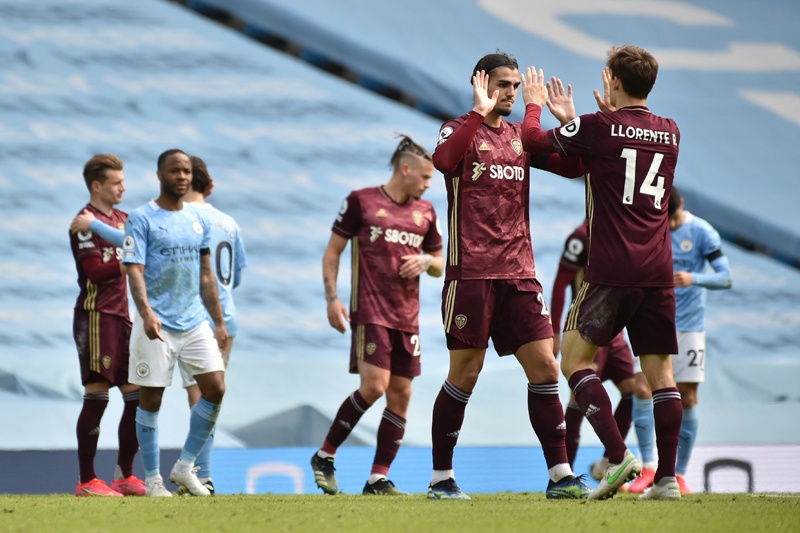 MANCHESTER: Leeds players celebrate at the end of the English Premier League football match between Manchester City and Leeds United at the Etihad Stadium in Manchester, north west England yesterday. – AFPn