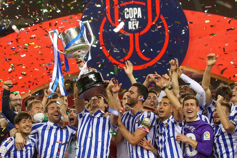 SEVILLE: A handout picture released by the Spanish Football Federation (RFEF) shows Real Sociedad's players celebrating with the trophy after winning the 2020 Spanish Copa del Rey (King's Cup) final football match between Athletic Bilbao and Real Sociedad at La Cartuja stadium in Sevilla on Saturday. - AFPn