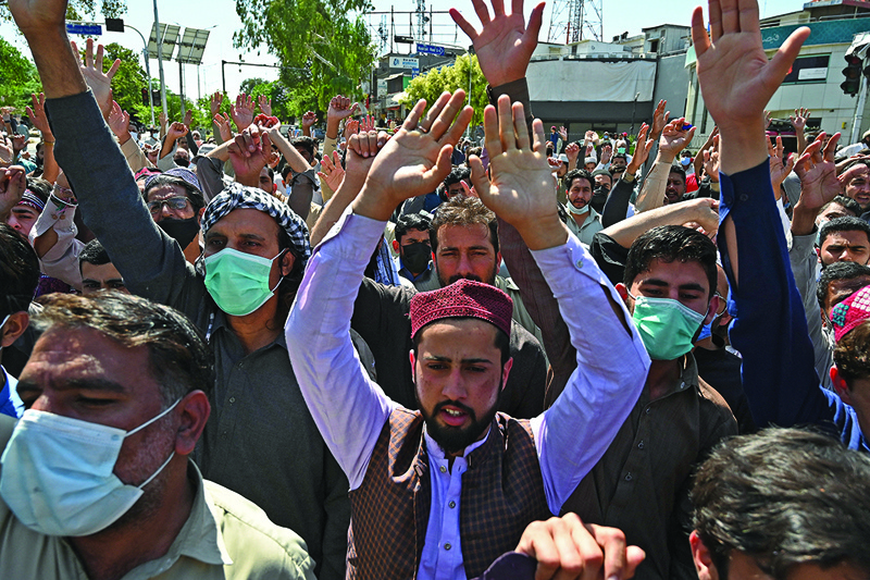 ISLAMABAD: Traders shout slogans as they take part in a protest at a closed market area during a nationwide strike called by various groups to show solidarity with the Tehreek-e-Labbaik Pakistan (TLP) party after TLP's leader was detained following his calls for the expulsion of the French ambassador, in Islamabad yesterday.-AFPn