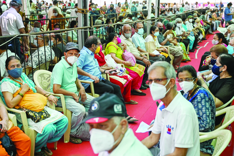 MUMBAI: People queue up to receive a dose of a COVID-19 coronavirus vaccine at a vaccination center yesterday.-AFPn