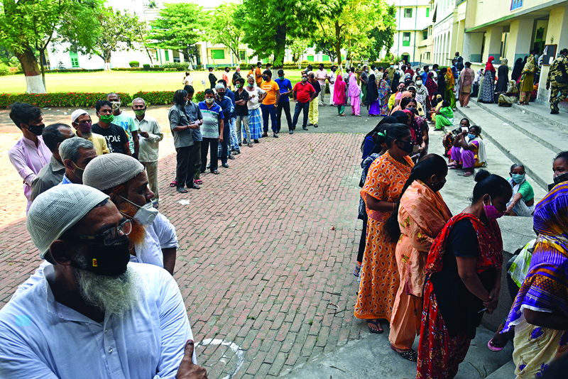 KOLKATA: Voters queue up to cast their ballot during the final phase of West Bengal's state legislative assembly elections in Kolkata yesterday.-AFPn
