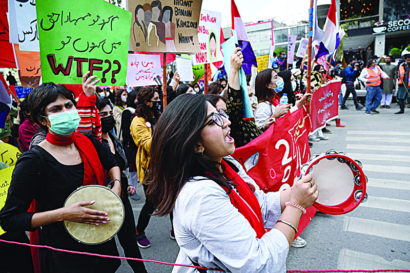 ISLAMABAD: In this file photo taken on March 8, 2021 activists of the 'Aurat March' shout slogans and carry placards during a rally to mark International Women's Day in Islamabad. - AFPn