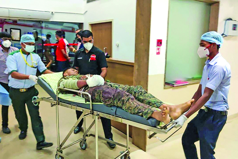 BIJAPUR, India: Medical workers bring an injured soldier on a stretcher for treatment in a hospital in Bijapur following a gun battle with Maoist rebels, which left twenty-two member of Indian security forces killed and 30 others wounded. - AFPn