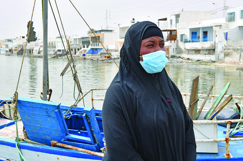 TUNIS: Aminata Traoure, a 28-year-old refugee from Ivory Coast who survived a shipwreck in early March while trying to reach Europe, stands on a pier by a fishing boat in the Tunisian coastal city of Sfax, about 270km southeast of the capital.—AFPn