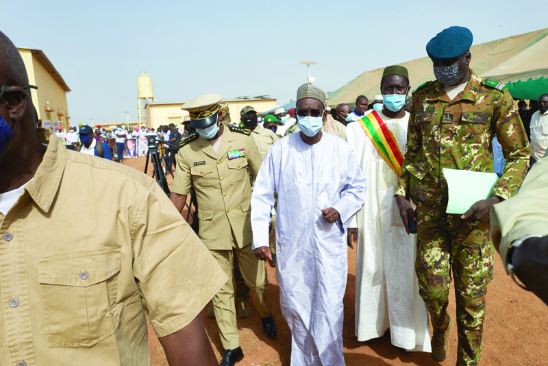 In this file photo taken on March 20, 2021 Malian Prime Minister Moctar Ouane and his delegation attend the inauguration of the new river port of Konna in central Mali. - AFPn
