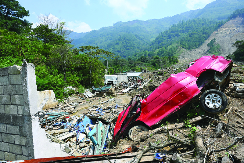 QUEJA, Guatemala: This photo shows a view of a destroyed car in the Guatemalan village of Queja, San Cristobal Verapaz municipality, Alta Verapaz department, which was destroyed by a landslide caused by heavy rains from the hurricanes that hit Central America.-AFP nn