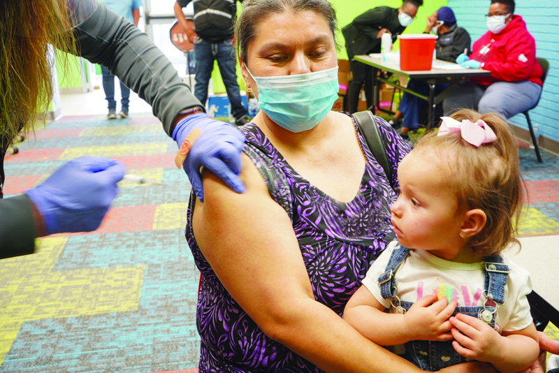 PASADENA, Texas: A healthcare worker vaccinates a woman with the COVID-19 vaccine, as the Pasadena Public Library hosts a mobile vaccine clinic set up by the Harris County Public Health. -- AFPn