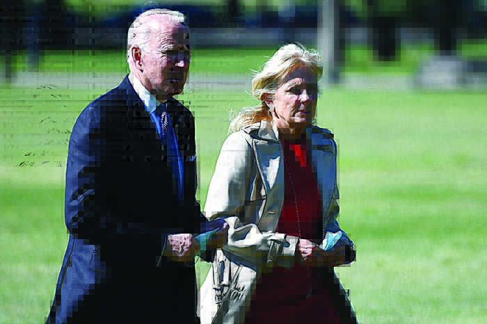 WASHINGTON: US President Joe Biden and First Lady Jill Biden walk across The Ellipse, near the White House, upon return to Washington, DC yesterday. —AFP