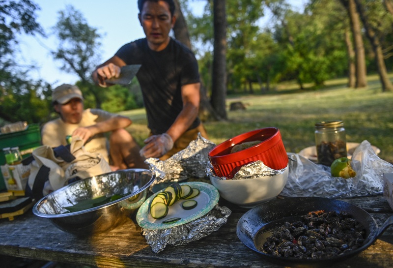 Chef Bun Lai prepares to make fried cicada sushi at Fort Totten Park in Washington, DC.-AFP photosn
