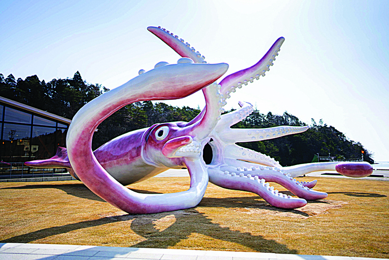 This handout photograph shows a giant squid statue, built at a cost of nearly 250,000 USD with a national tax grant to aid communities hit financially by COVID-19 restrictions, in the town of Noto, Ishikawa prefecture.-AFP n