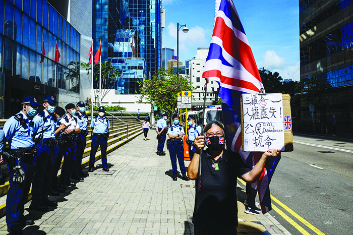HONG KONG: Alexandra Wong (right), an activist known as Grandma Wong, holds a British Union Jack flag outside the District Court in Hong Kong, as nine pro-democracy activists await their sentencing for charges of unauthorized assembly on China’s National Day on October 1, 2019. — AFP