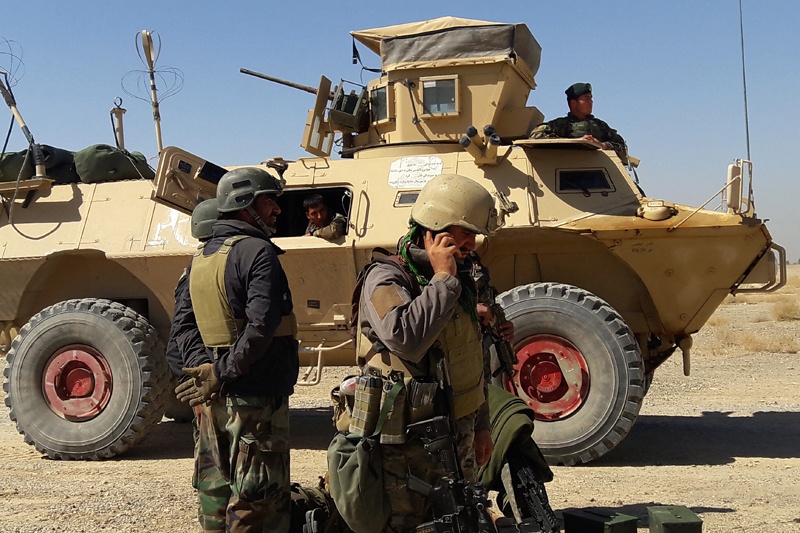 In this file photo, Afghan security forces stand near an armored vehicle during ongoing fighting between Afghan security forces and Taleban fighters in the Busharan area on the outskirts of Lashkar Gah.—AFPn