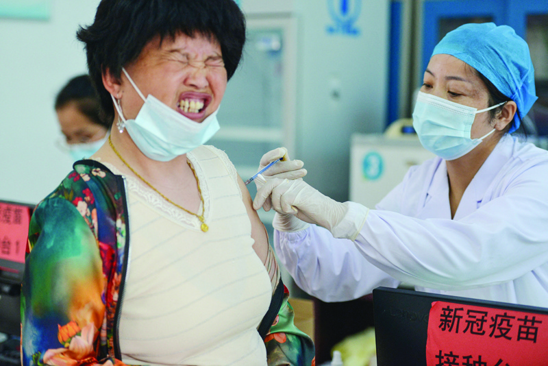 A resident receives the Anhui Zhifei Longcom COVID-19 vaccine in Linquan county, Fuyang city, in China's eastern Anhui province. - AFPn