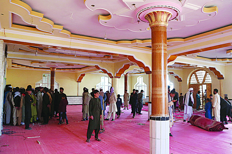KABUL: Devotees gather inside a mosque after a bomb blast on the outskirts of Kabul that killed at least 12 people, shattering the relative calm of a holiday ceasefire between the warring Taleban and government forces. - AFPn