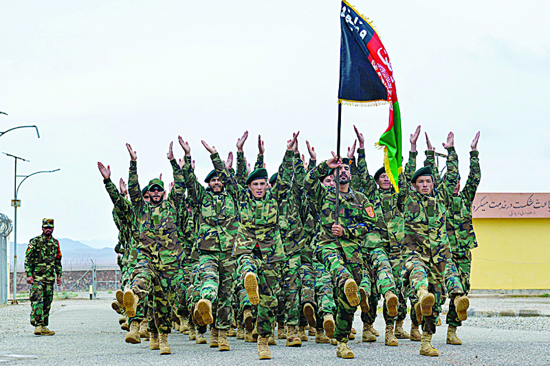 HERAT: Afghan National Army (ANA) soldiers march during a ceremony at a military base in the Guzara district of Herat Wednesday.-AFPn