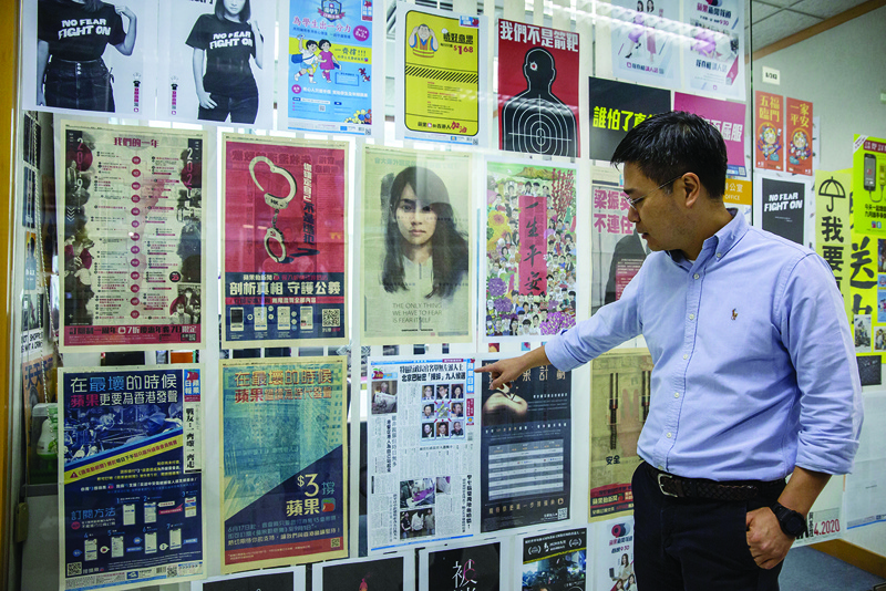 HONG KONG: This file photo shows Apple Daily editor-in-chief Ryan Law pointing to a copy of the first newspaper front page in the newsroom in Hong Kong. -AFP n