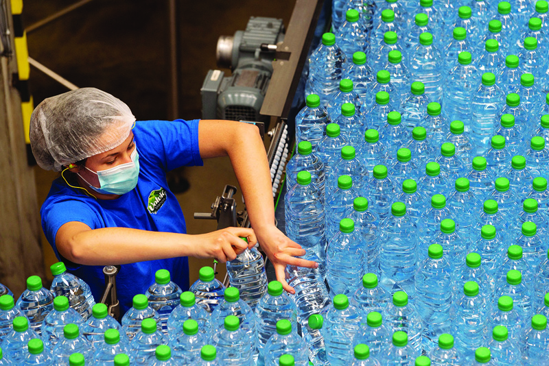VOLVIC, France: Employees work at the French mineral water company Volvic on May 5, 2021. - AFP n