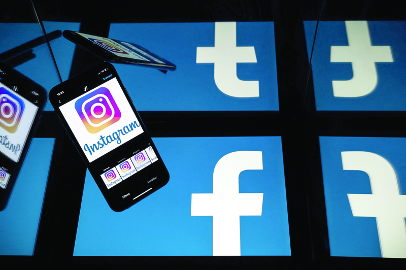 Logos of US social networks Facebook and Instagram on the screens of a tablet and a mobile phone. - AFP n
