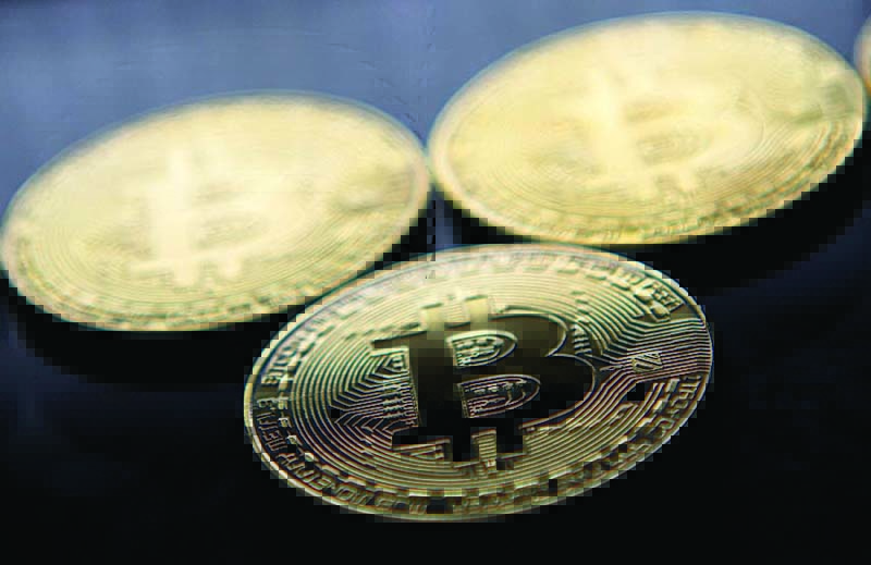 (FILES) This file photo taken on November 20, 2017 shows gold plated souvenir Bitcoin coins arranged for a photograph in London. - Bitcoin plunged below 39,000 USD for the first time in more than three months on May 19, 2021 after China said cryptocurrencies would not be allowed in transactions and warned investors against speculative trading in them, despite the country powering most of the world's mining. (Photo by Justin TALLIS / AFP)