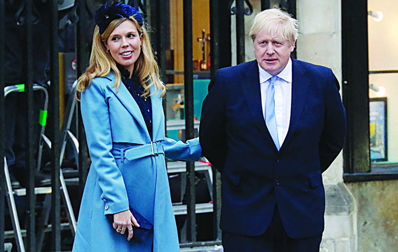 In this file photo, Britain's Prime Minister Boris Johnson (right) with his partner Carrie Symonds leave after attending the annual Commonwealth Service at Westminster Abbey in London on March 09, 2020. - AFPn
