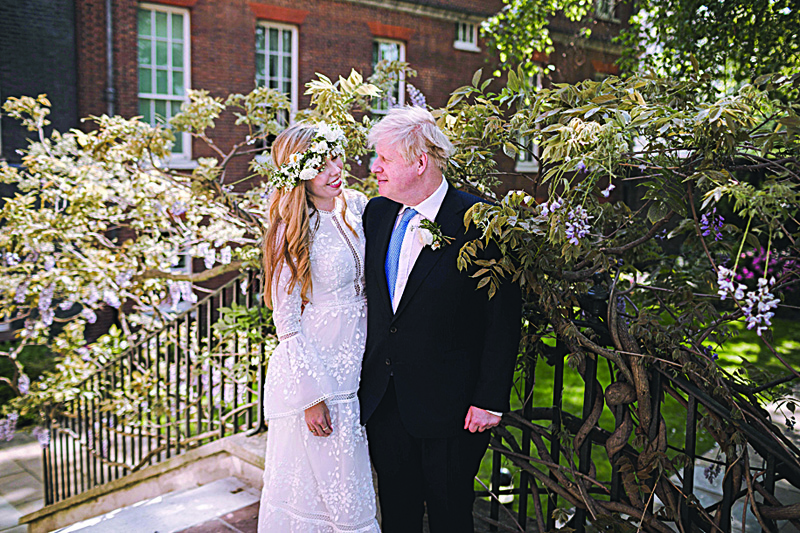 LONDON:  A handout picture shows Britain's Prime Minister Boris Johnson and his wife Carrie Johnson in the garden of 10 Downing Street, London after their wedding on Saturday.-AFP n
