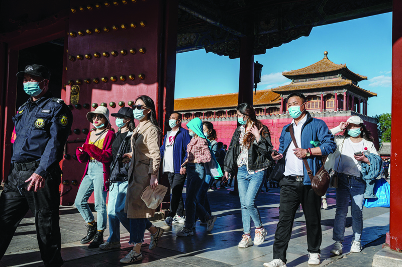 BEIJING: People walk outside the Forbidden City during the Labor Day holiday in Beijing yesterday.-AFPn