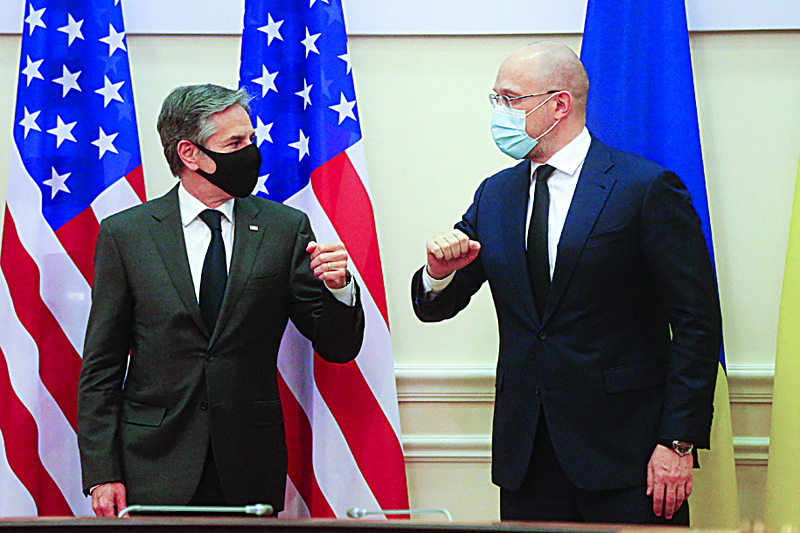 KIEV: US Secretary of State Antony Blinken (left) and Ukraine's Prime Minister Denis Shmygal greet each other prior to their talks in Kiev yesterday.-AFPn