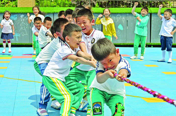 YANTAI, China: Children play at a kindergarten in China’s eastern Shandong province yesterday. — AFP