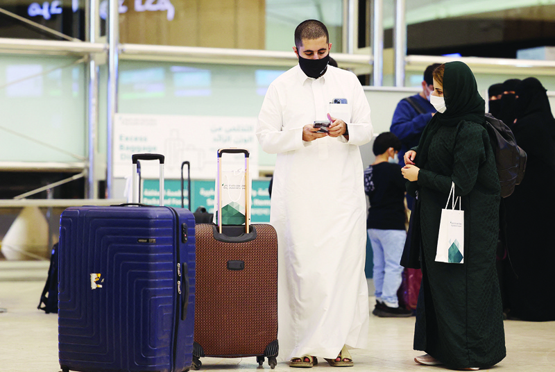 RIYADH: Saudi passengers arrive at King Khaled International Airport on May 17, 2021 after authorities lifted travel restrictions for citizens immunized against COVID-19. – AFP n