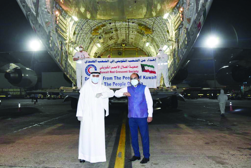 NEW DELHI: Kuwaiti Ambassador to India Jassem Al-Najem (left) and Joint Secretary, Gulf, at the Indian External Affairs Ministry Ambassador Vipul pose for a picture outside a plane carrying medical aid from Kuwait to India. - KUNA photosn