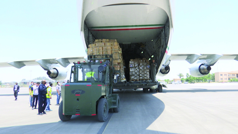 CAIRO: Gaza-bound aid from Kuwait is unloaded from a plane that arrived in Cairo on Sunday. - KUNAn