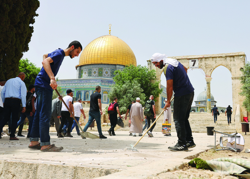 JERUSALEM: Palestinians clean Jerusalem's Al-Aqsa mosque compound yesterday after it was stormed by Zionist forces firing at the Palestinian worshippers with stun grenades and tear gas canisters.-- AFPn