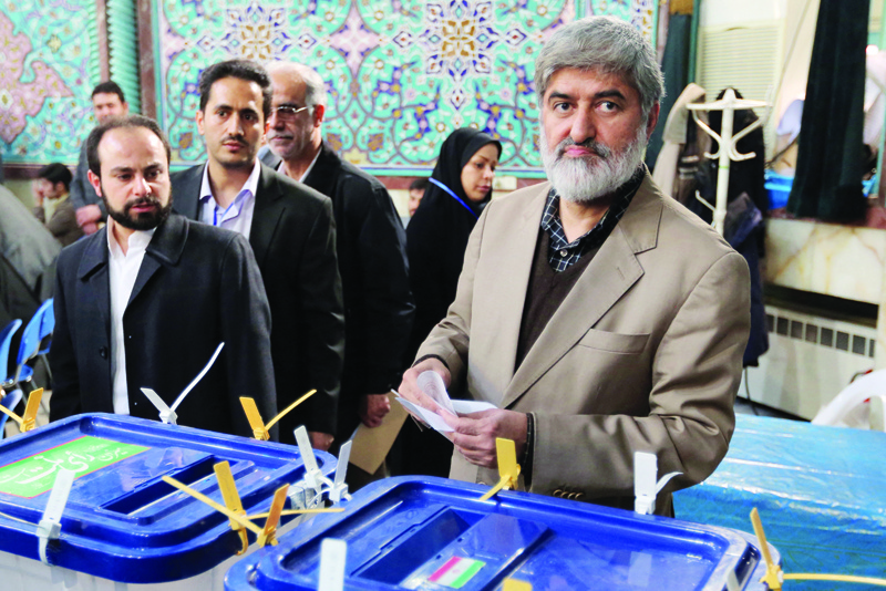 TEHRAN: In this file photo taken on February 26, 2016, Iranian candidate Ali Motahari (right) casts his ballot at a polling station in Tehran. The high number of presidential hopefuls from the ranks of the military for Iran's June 18 election is stirring unease over a possible militarization of the Islamic republic. -- AFPn