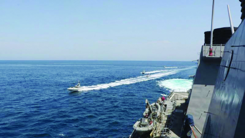 This handout photo courtesy of US Navy and made available yesterday two Iranian Islamic Revolutionary Guard Corps Navy (IRGCN) fast in-shore attack craft (FIAC), a type of speedboat armed with machine guns, conducting maneuvers while operating in close proximity to US naval vessels transiting the Strait of Hormuz. - AFPn