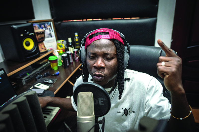 Ghana Afropop musician, Stonebwoy, sings during a recording session at his studio in his house in Accra, Ghana.-AFP photosn