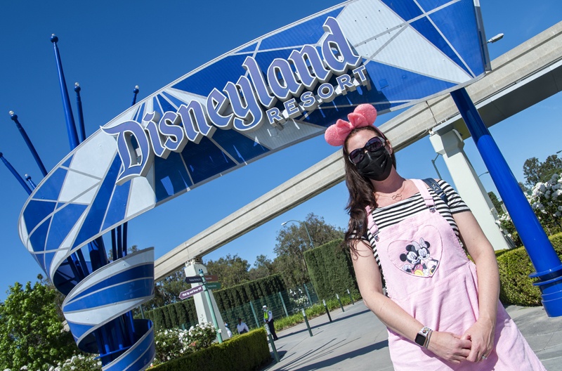 Visitors pose as they enter Disneyland on the day of the park's re-opening, in Anaheim, California.-AFP photosn